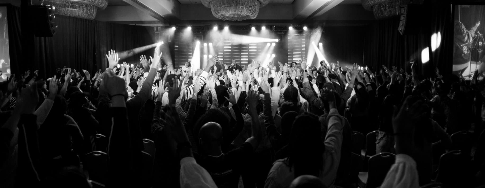 A worship gathering with hands raised