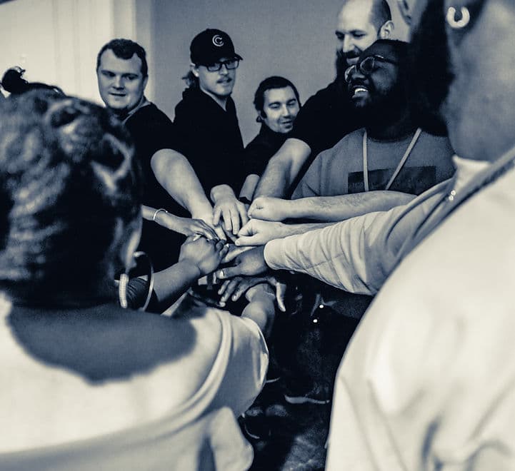 Impact conference attendees joining hands