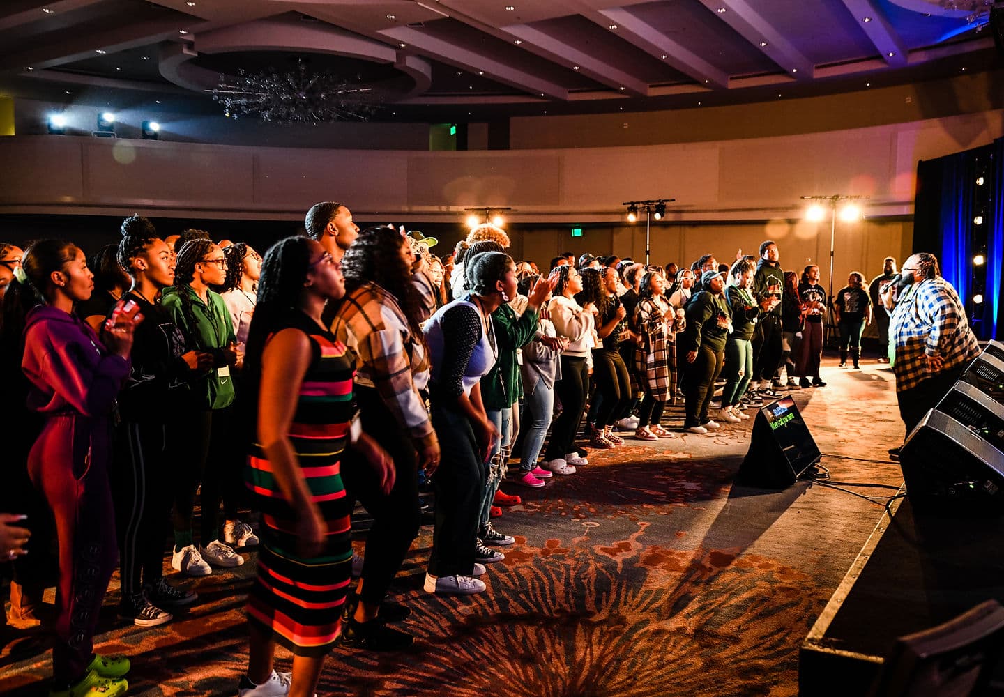 Impact Movement conference attendees worshipping together