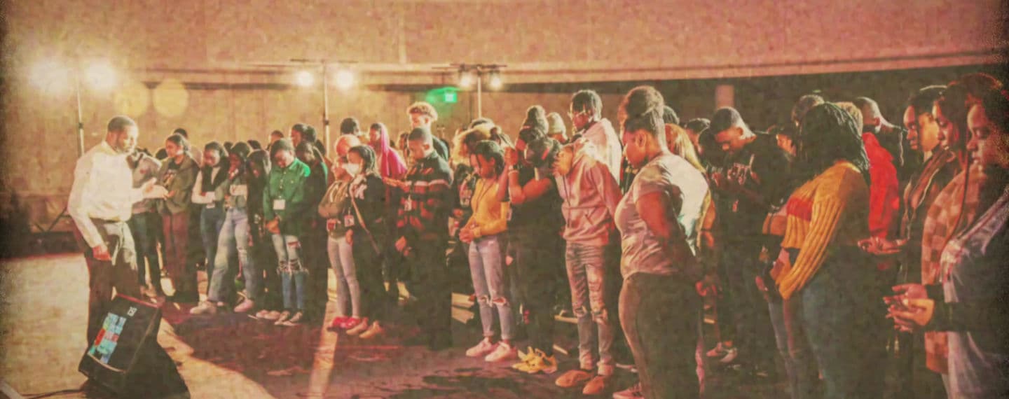 Impact conference attendees gathered in prayer
